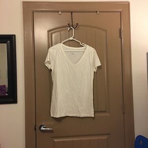 Cream top with slightly ruffled shoulders